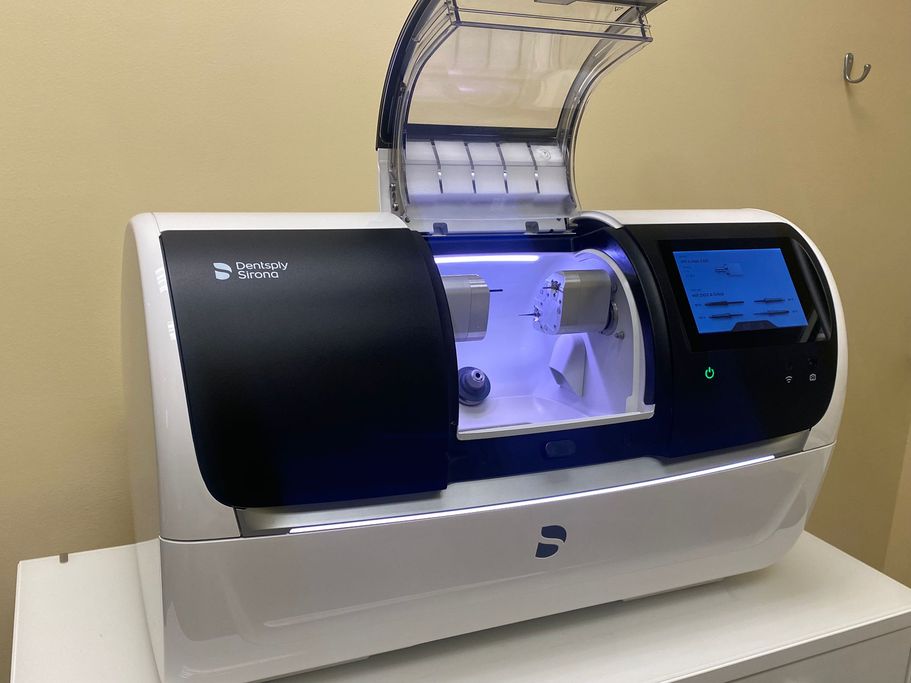 Advanced dental technology at The Village Dental in Pinecrest, FL, featuring a milling machine for same-day crowns and restorative procedures.