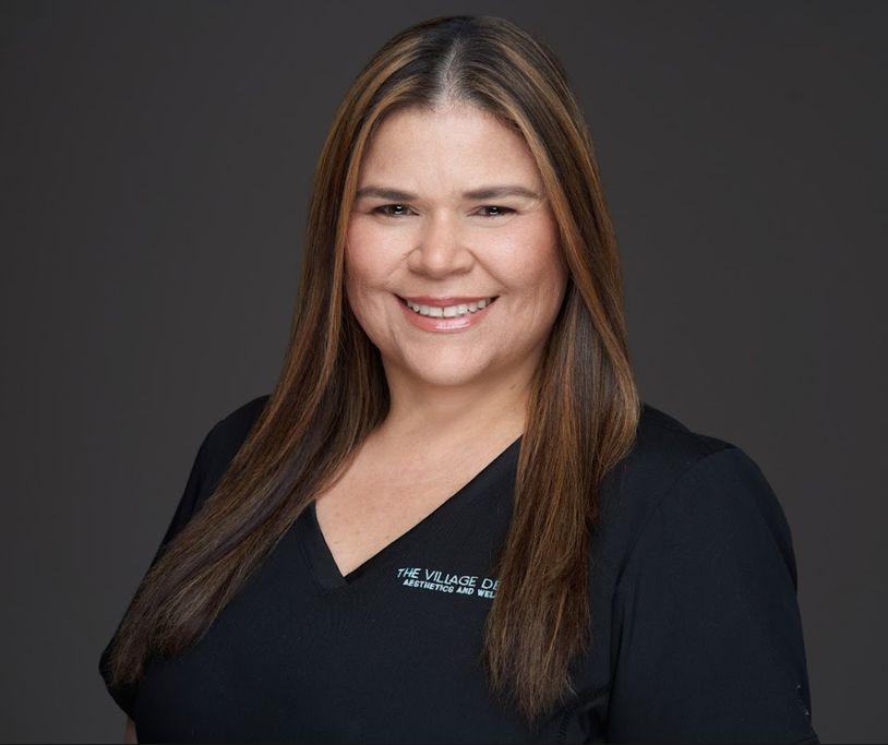 Arlyn Alarcon, Office Manager at The Village Dental, smiling in a professional dental uniform, representing comprehensive dental care in Pinecrest, FL.