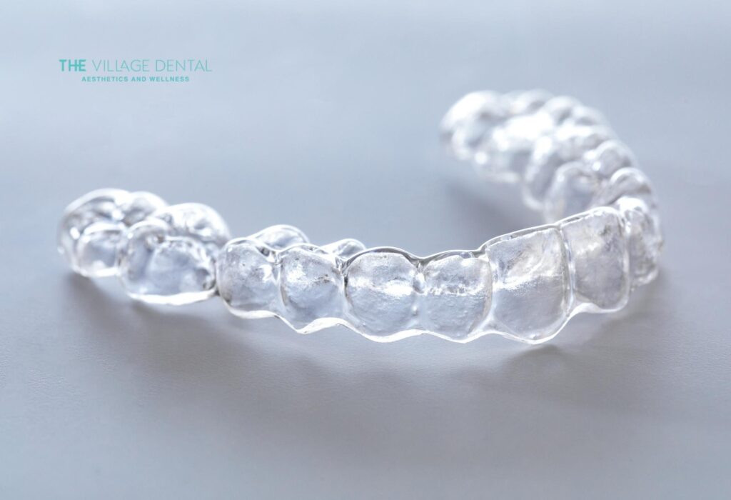 Clear Invisalign aligner from The Village Dental, representing comfortable and discreet orthodontic treatment for patients in Pinecrest, FL.