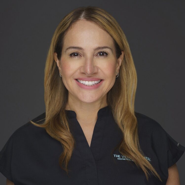 Leda Rosales, dental hygienist at The Village Dental in Pinecrest, FL, smiling in a professional setting, showcasing commitment to patient care and oral health education.