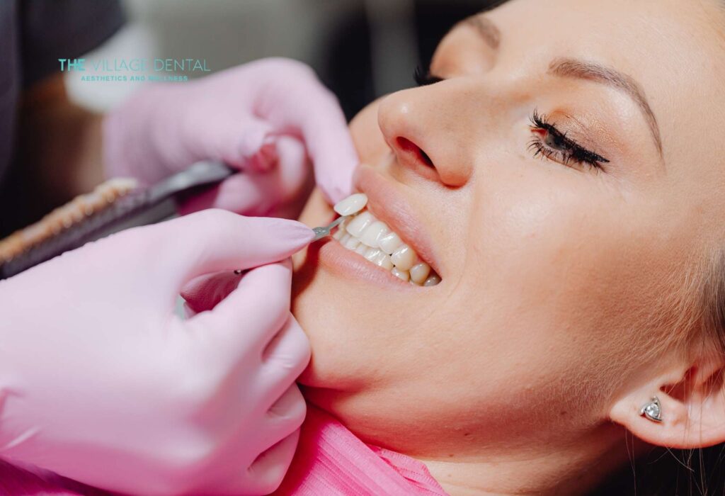 Woman receiving dental care at The Village Dental in Pinecrest, FL, showcasing the application of same-day ceramic veneers for an enhanced smile.