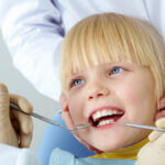 Child smiling during a dental checkup at The Village Dental in Pinecrest, FL, showcasing a positive and welcoming experience for young patients.