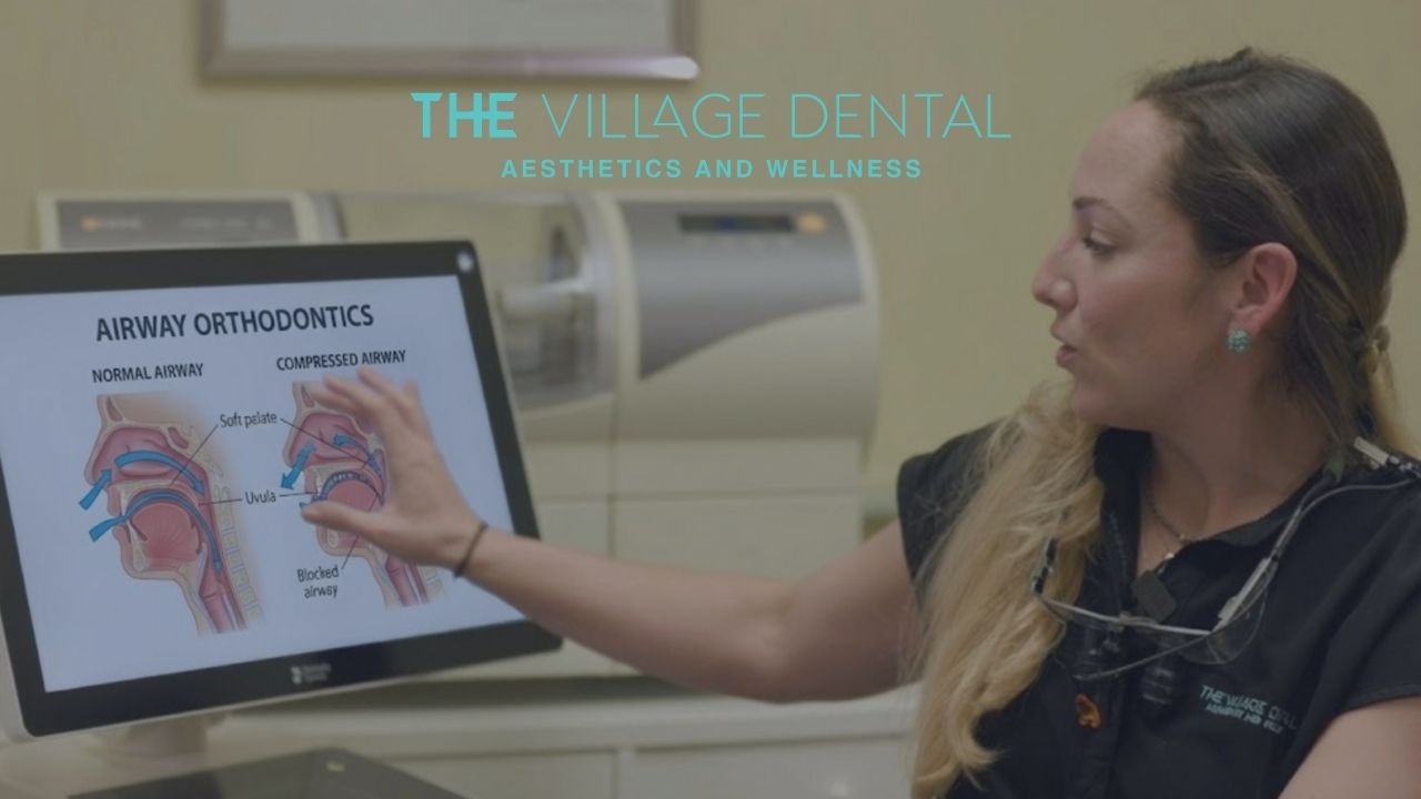 Dental professional explaining airway orthodontics with anatomical diagrams of normal and compressed airways at The Village Dental in Pinecrest, FL.